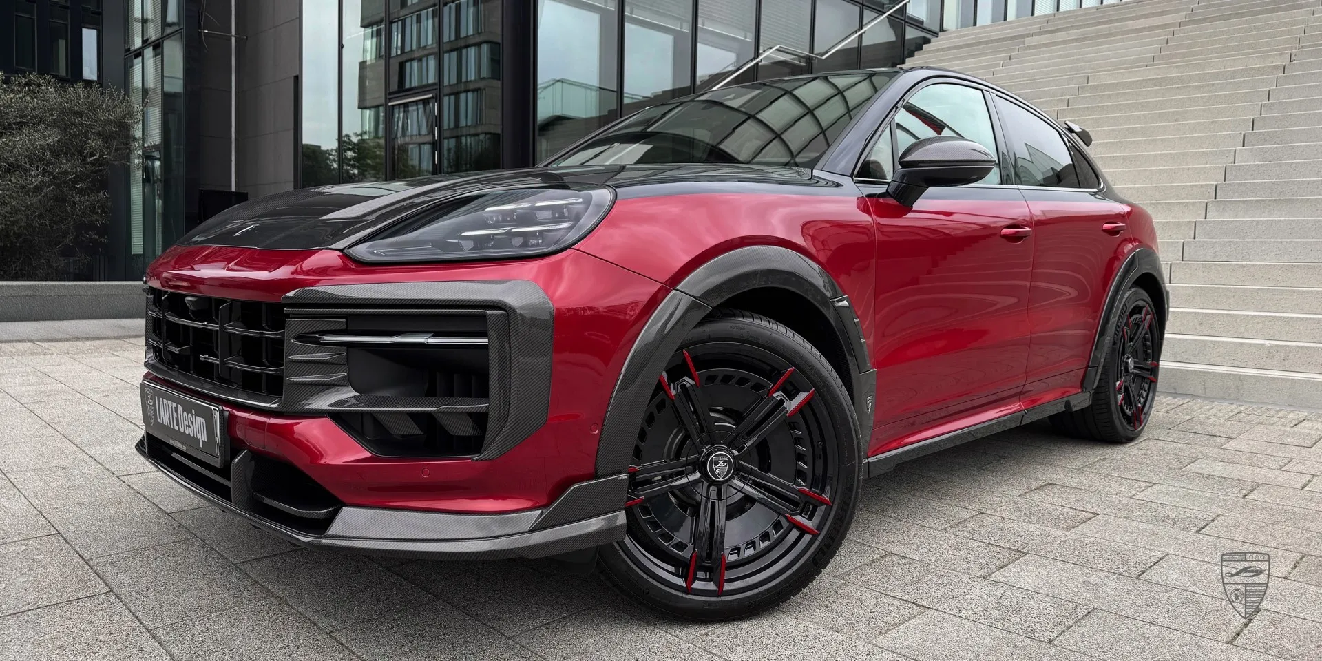 Close‑up of carbon fiber details and premium trims on the red Porsche Cayenne Coupe body kit
