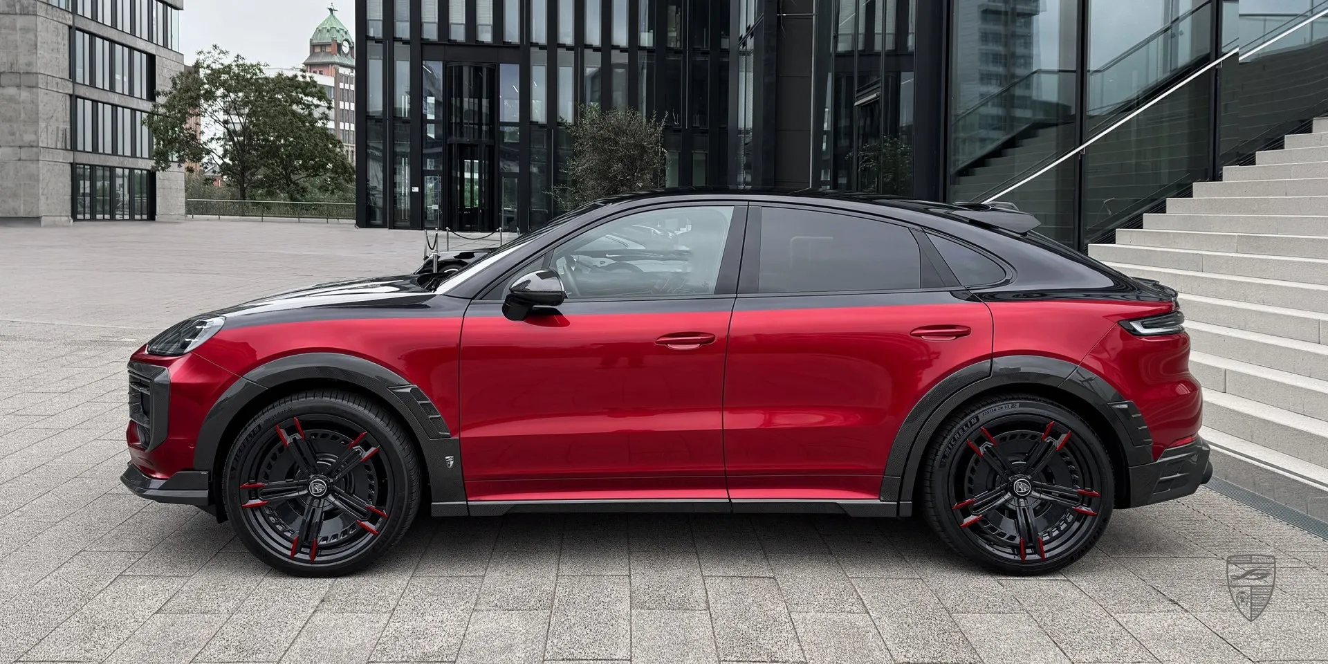 Side profile of the red Porsche Cayenne Coupe highlighting the body kit lines