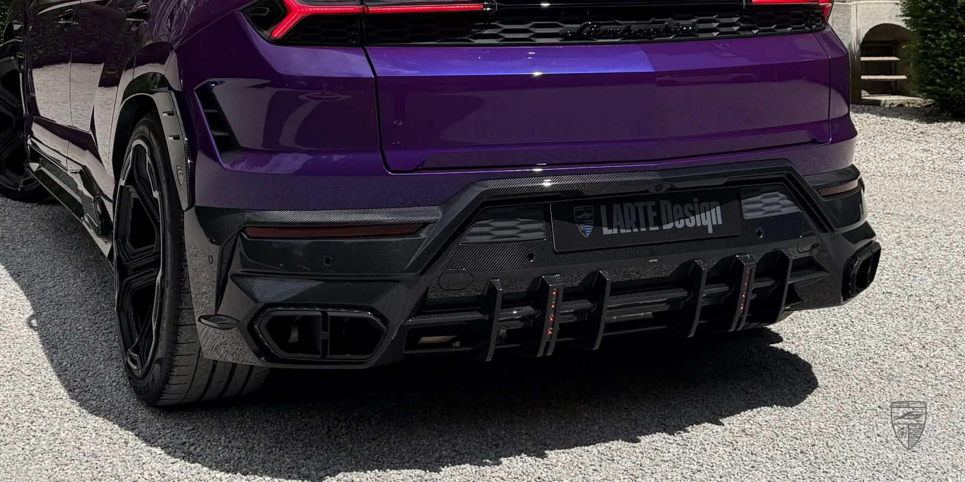 Carbon fiber details on a limited edition supercar — close‑up of rear diffuser and exhaust