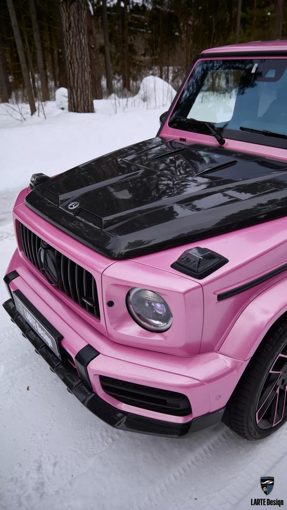 Pink Mercedes G-Class with a striking carbon fiber body kit, combining style and strength.