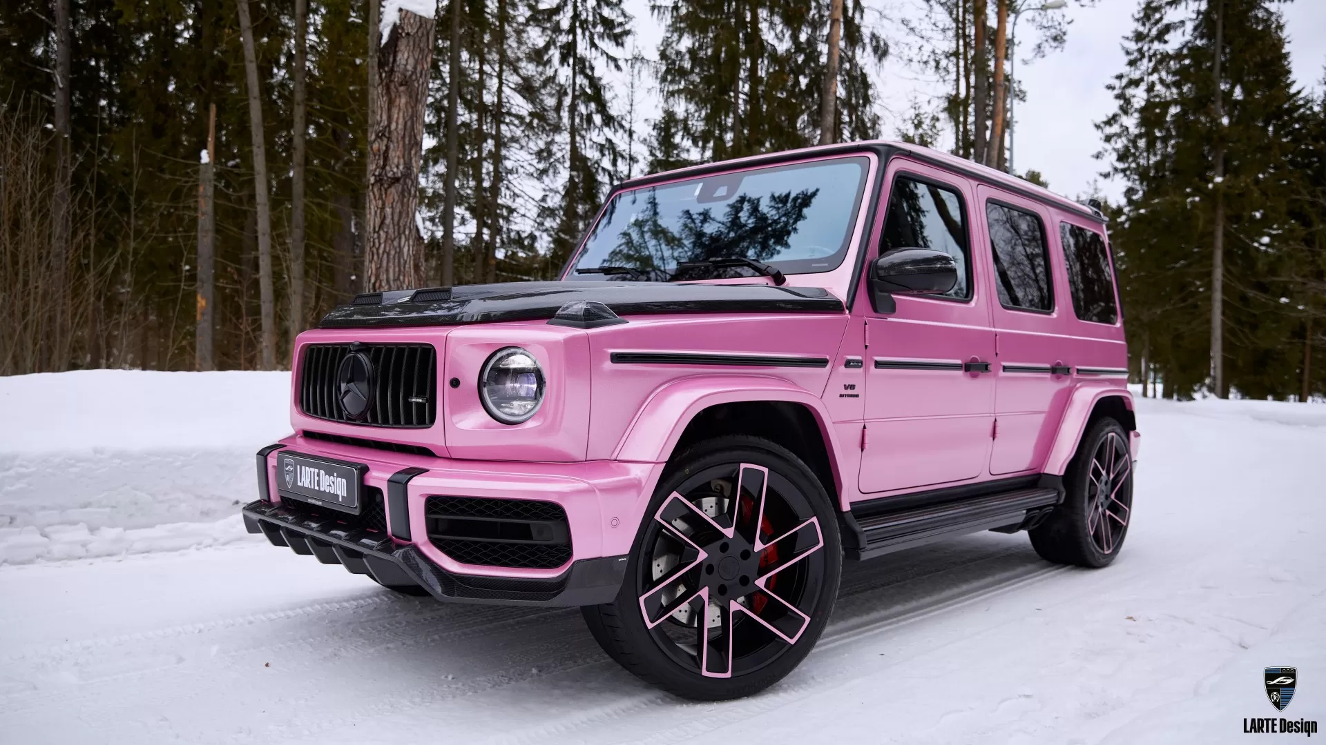 Pink Mercedes G-Class with a striking carbon fiber body kit, combining style and strength.