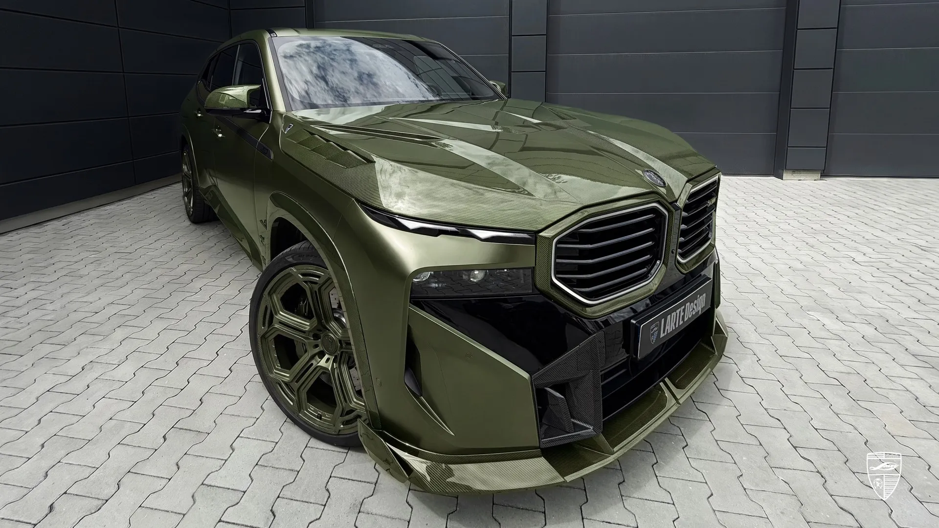 Body kit on the BMW XM highlighting the distinctive olive green color and refined design