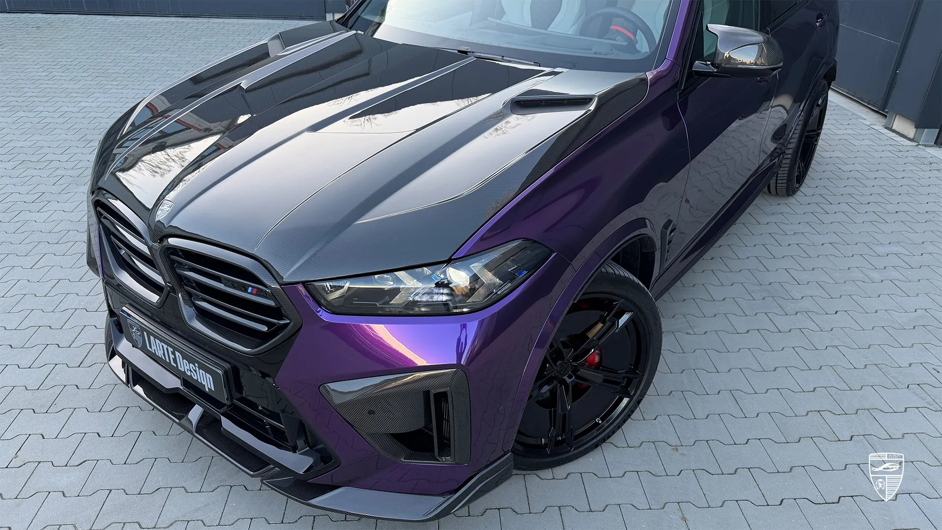 BMW F95 X5M LCI front view with signature headlights and bold styling