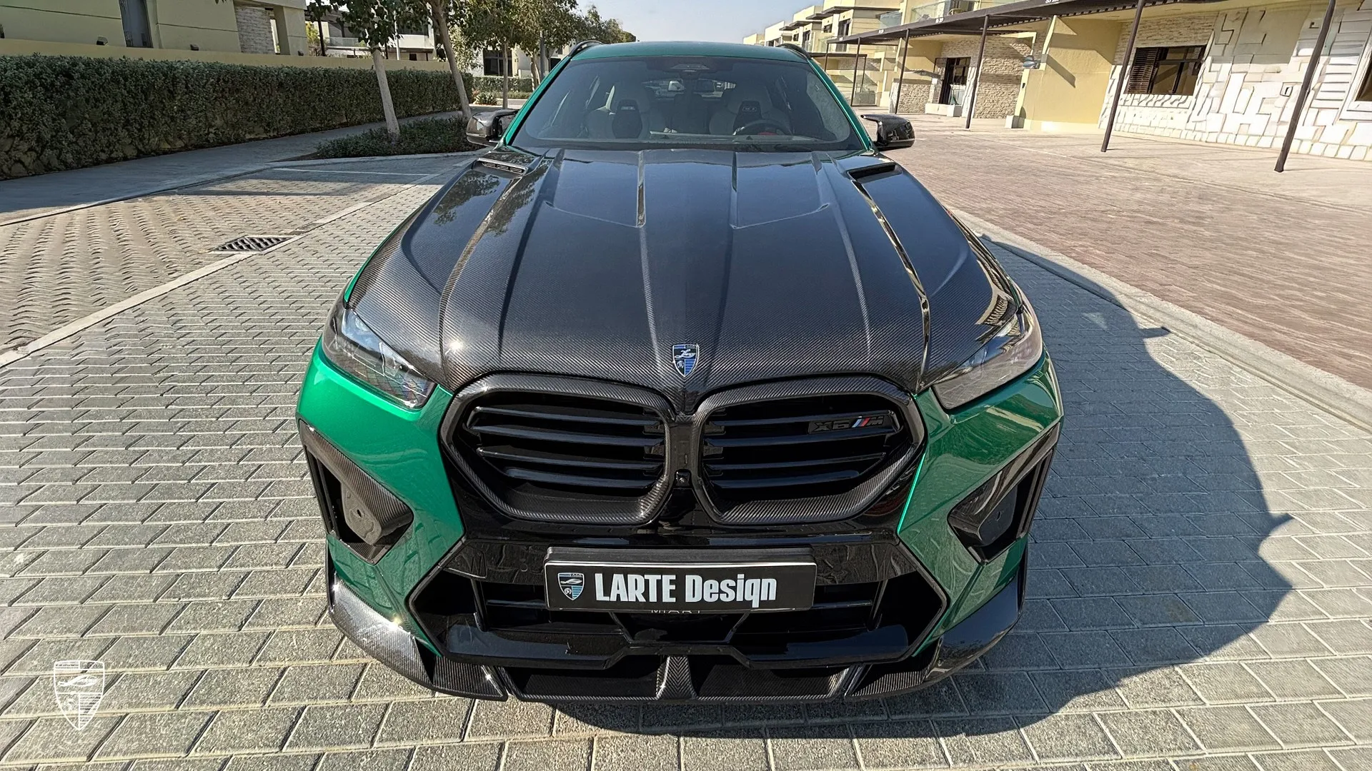 2026 X6M Competition F96 LCI: sculpted hood and carbon front splitter in Isle of Man Green
