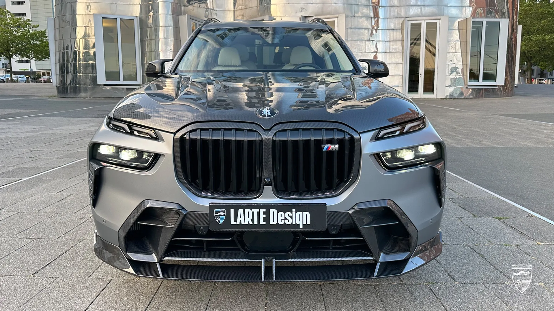 BMW X7 facelift front angle with wide illuminated grille and bold restyling design in luxury SUV segment
