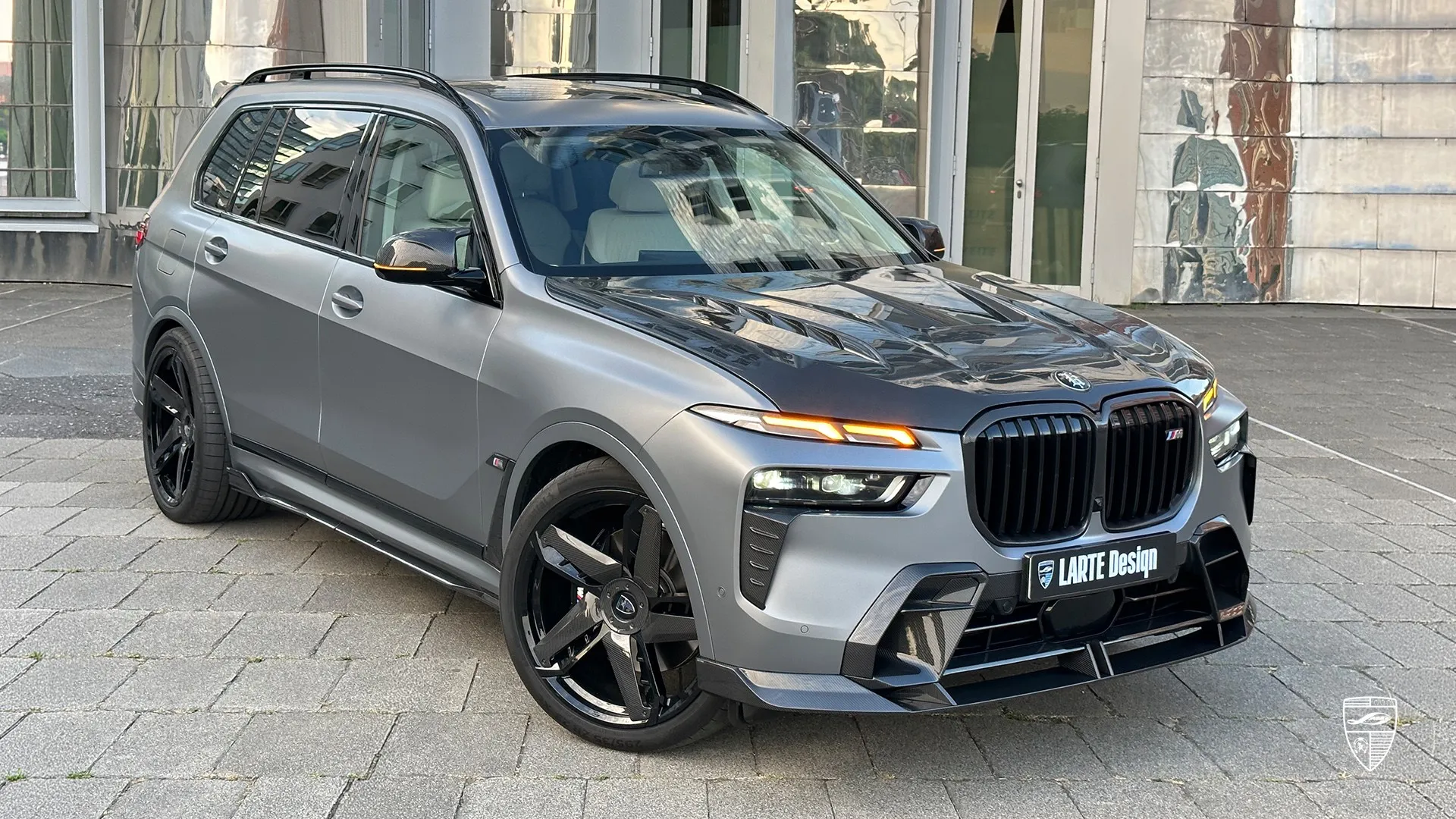 BMW X7 M60i xDrive G07 front three quarter view with carbon fiber body kit elements and aggressive tuning styling