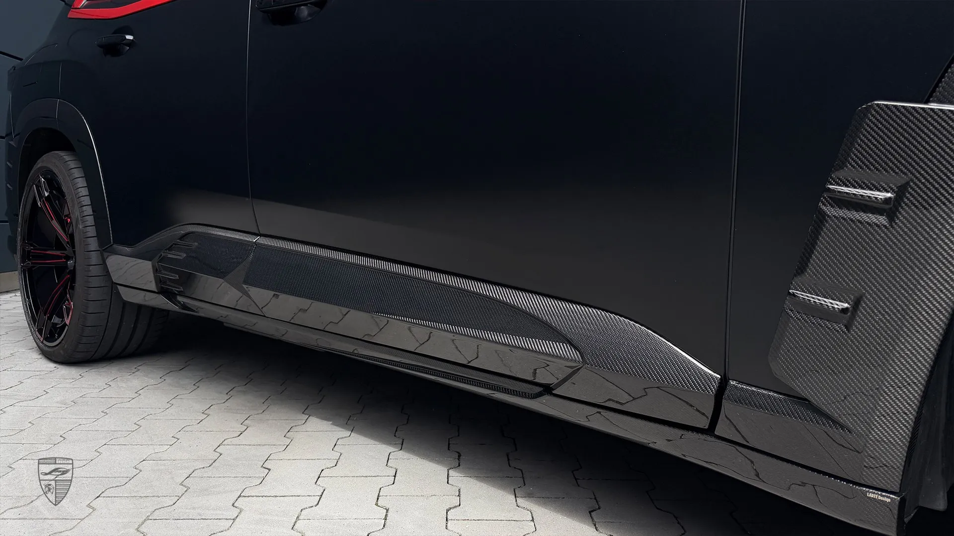 Black BMW XM with aggressive exterior styling and custom accessories