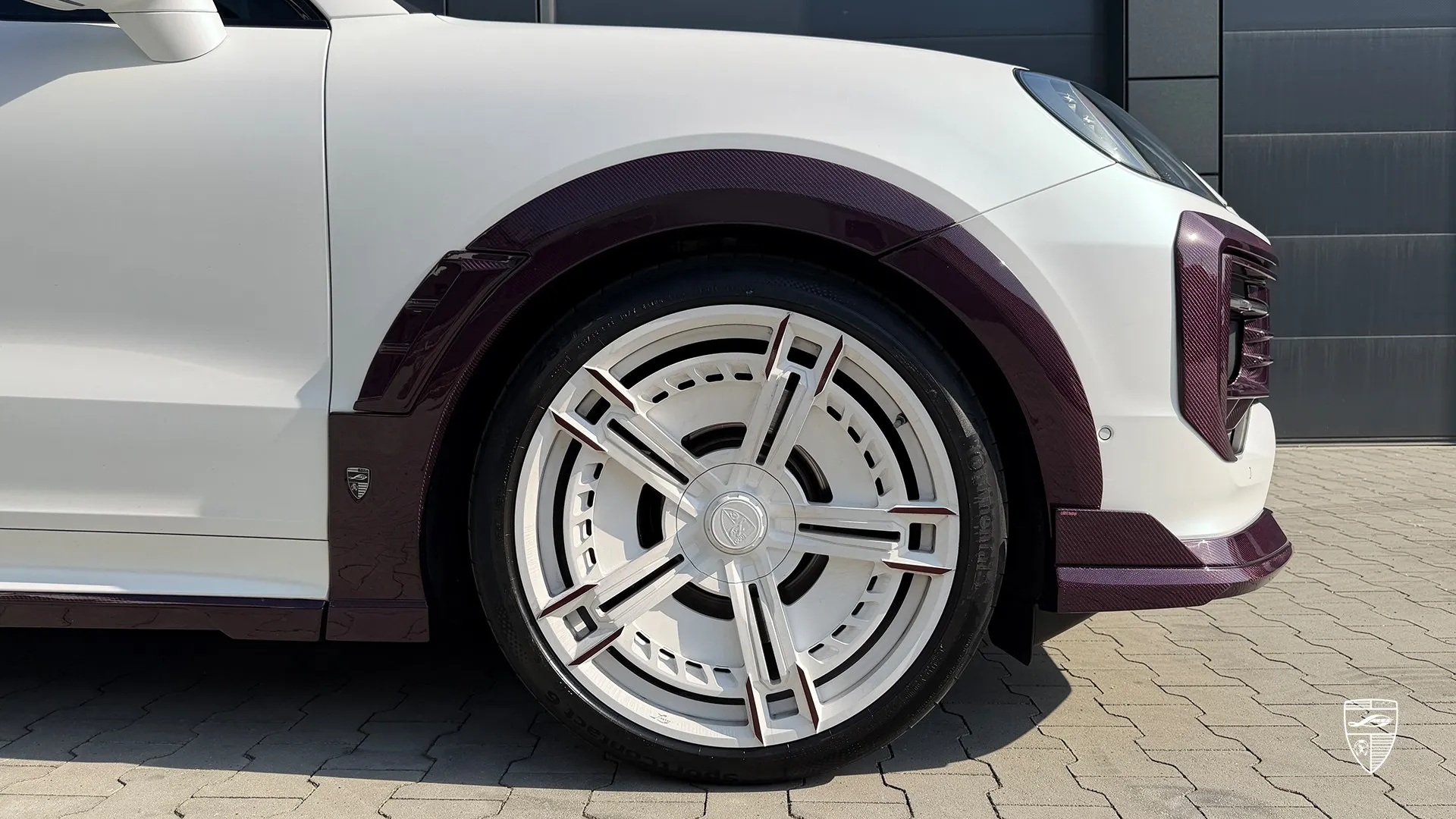 Porsche Cayenne white wheel detail featuring custom styling and premium exterior design