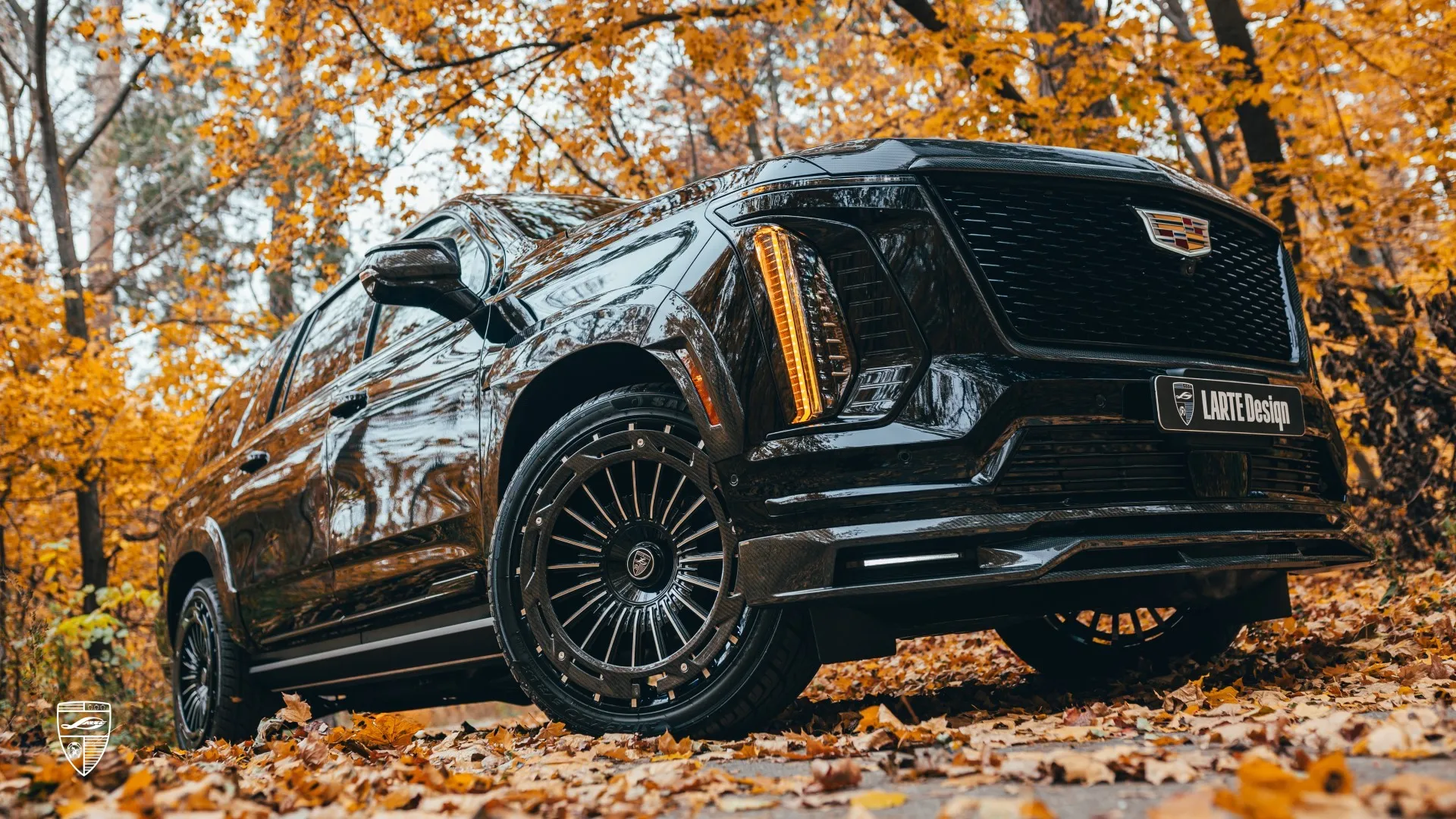 Cadillac Escalade 2025 black SUV with large custom wheels
