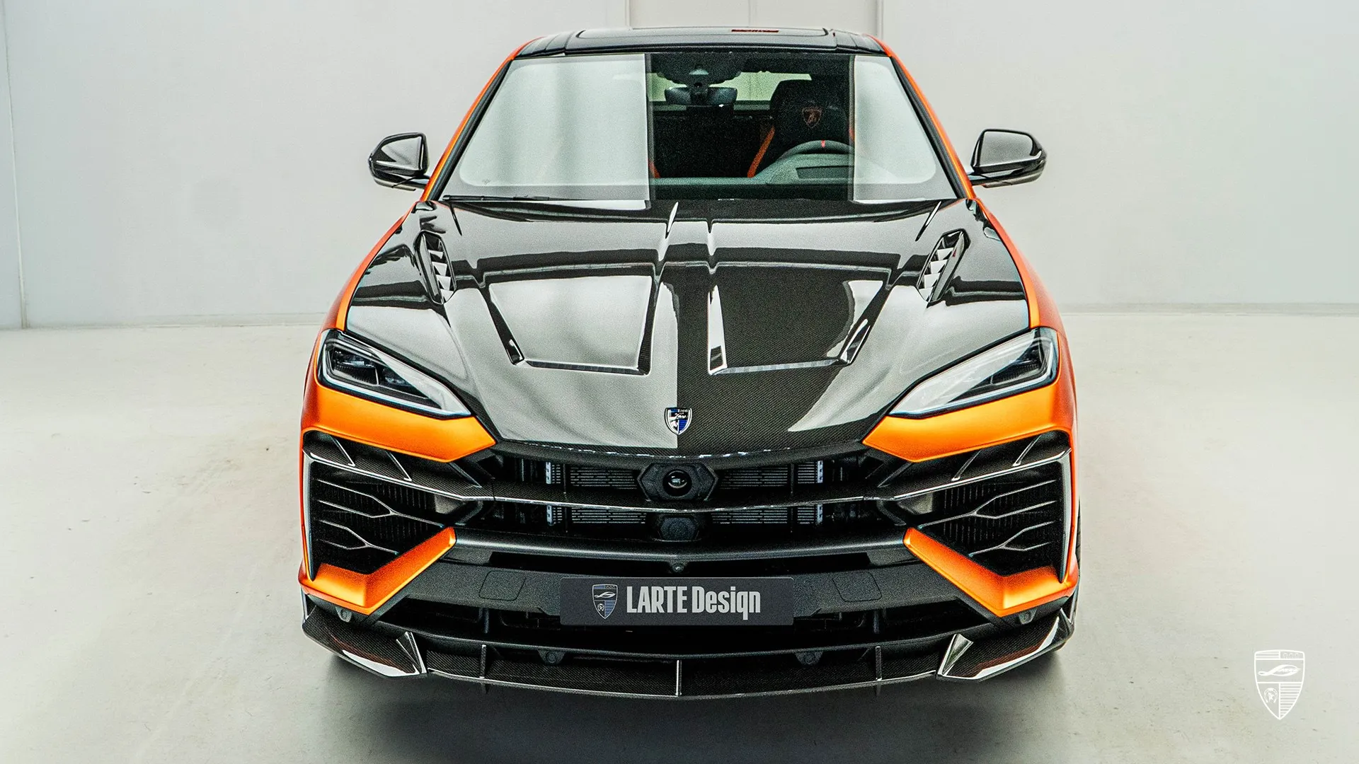 Lamborghini URUS SE in orange front view with carbon fiber hood styling and upgraded exterior design
