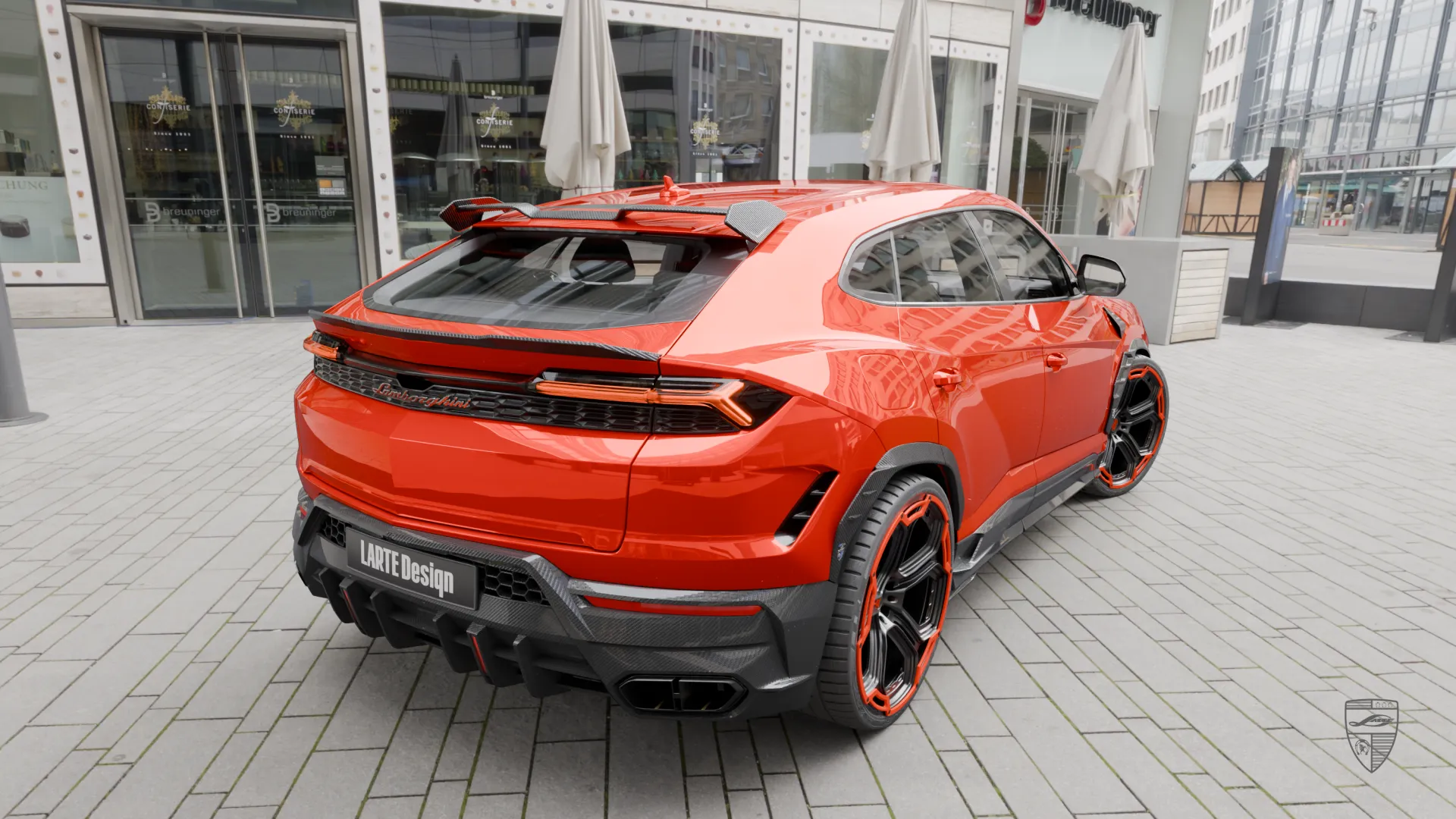 Lamborghini Urus SE orange rear three quarter view with carbon fiber body kit
