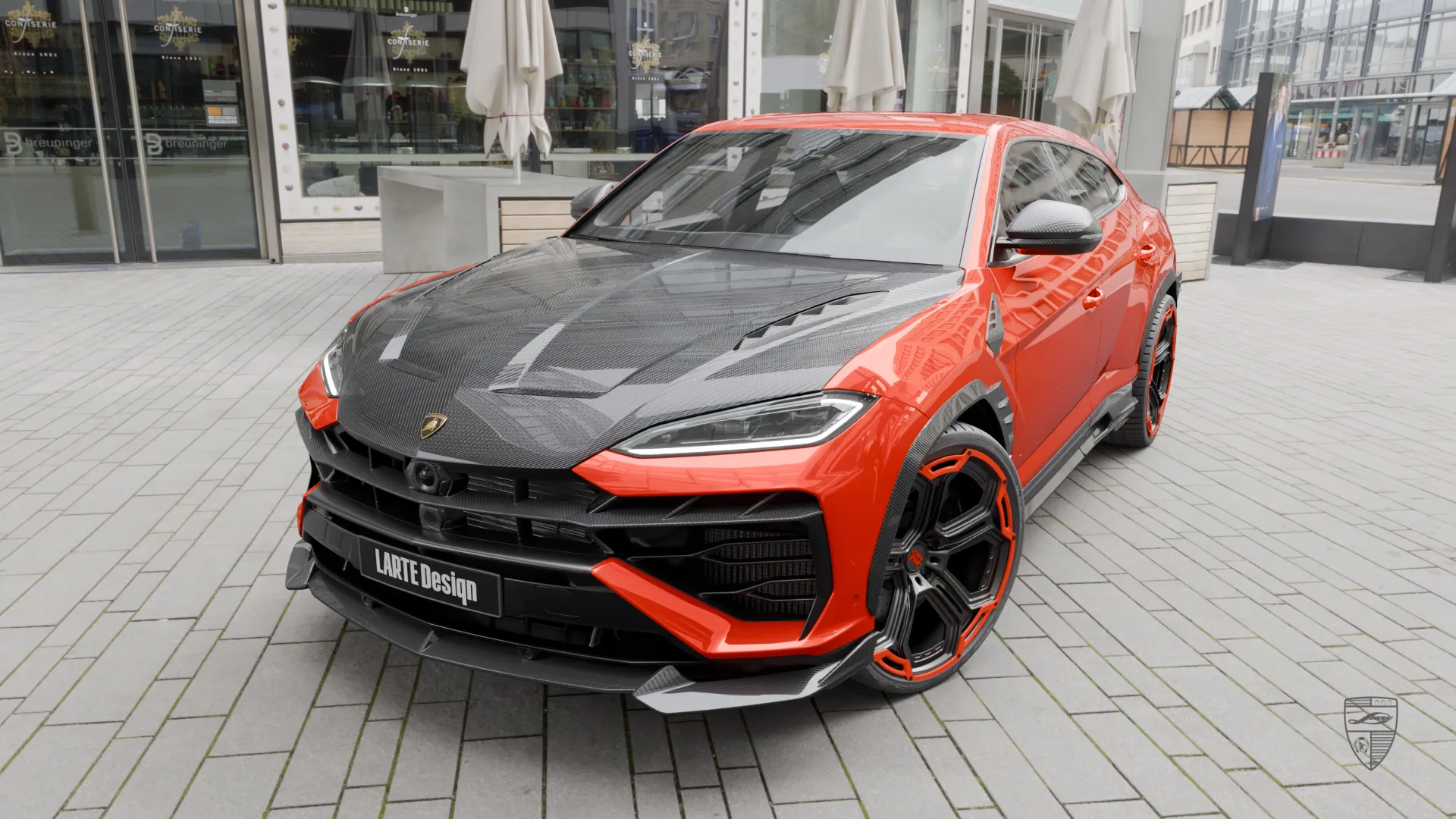 Lamborghini Urus SE front view in orange with carbon fiber hood and aggressive styling details