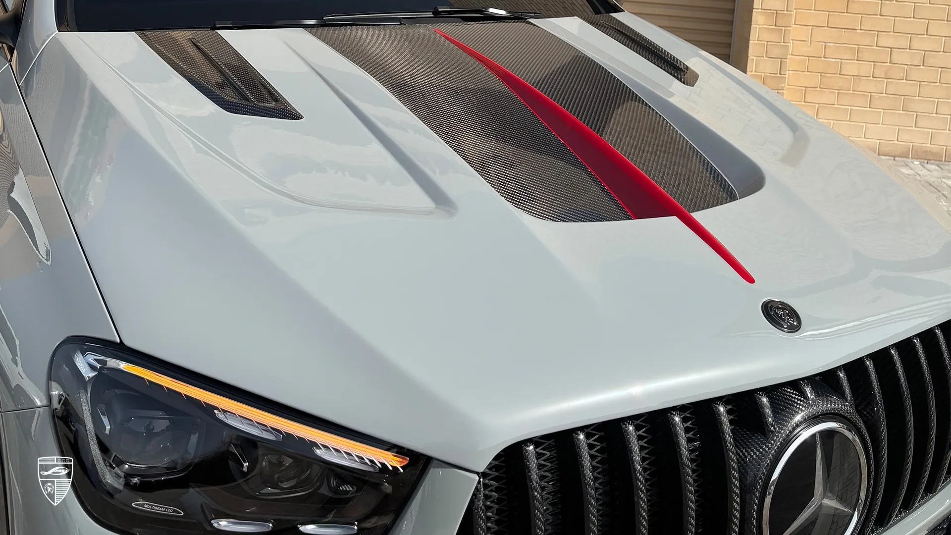 AMG GLE 53 Coupe Facelift hood detail with carbon fiber insert and red accent stripe