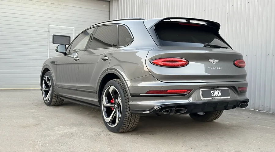 Rear angle view on a BENTLEY BENTAYGA MLB-2020-2024 with a body kit giving the car a custom appearance