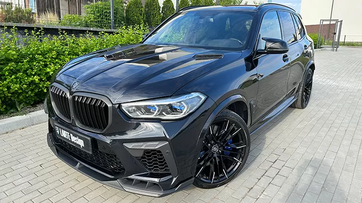 Front angle view on a BMW X5M Competition F95 with a body kit giving the car a custom appearance