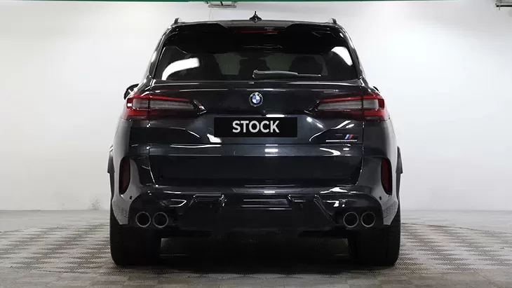 Rear view on a BMW X5M Competition F95 with a body kit giving the car a custom appearance
