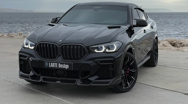 Front angle view on a BMW X6 with a body kit giving the car a custom appearance