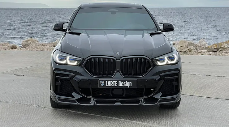 Front view on a BMW X6 with a body kit giving the car a custom appearance