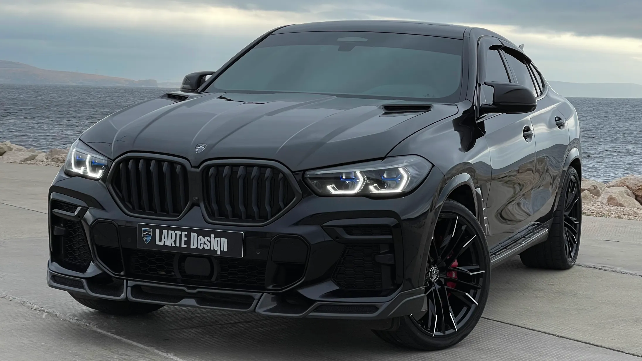 Front angle view on a BMW X6 with a body kit giving the car a custom appearance