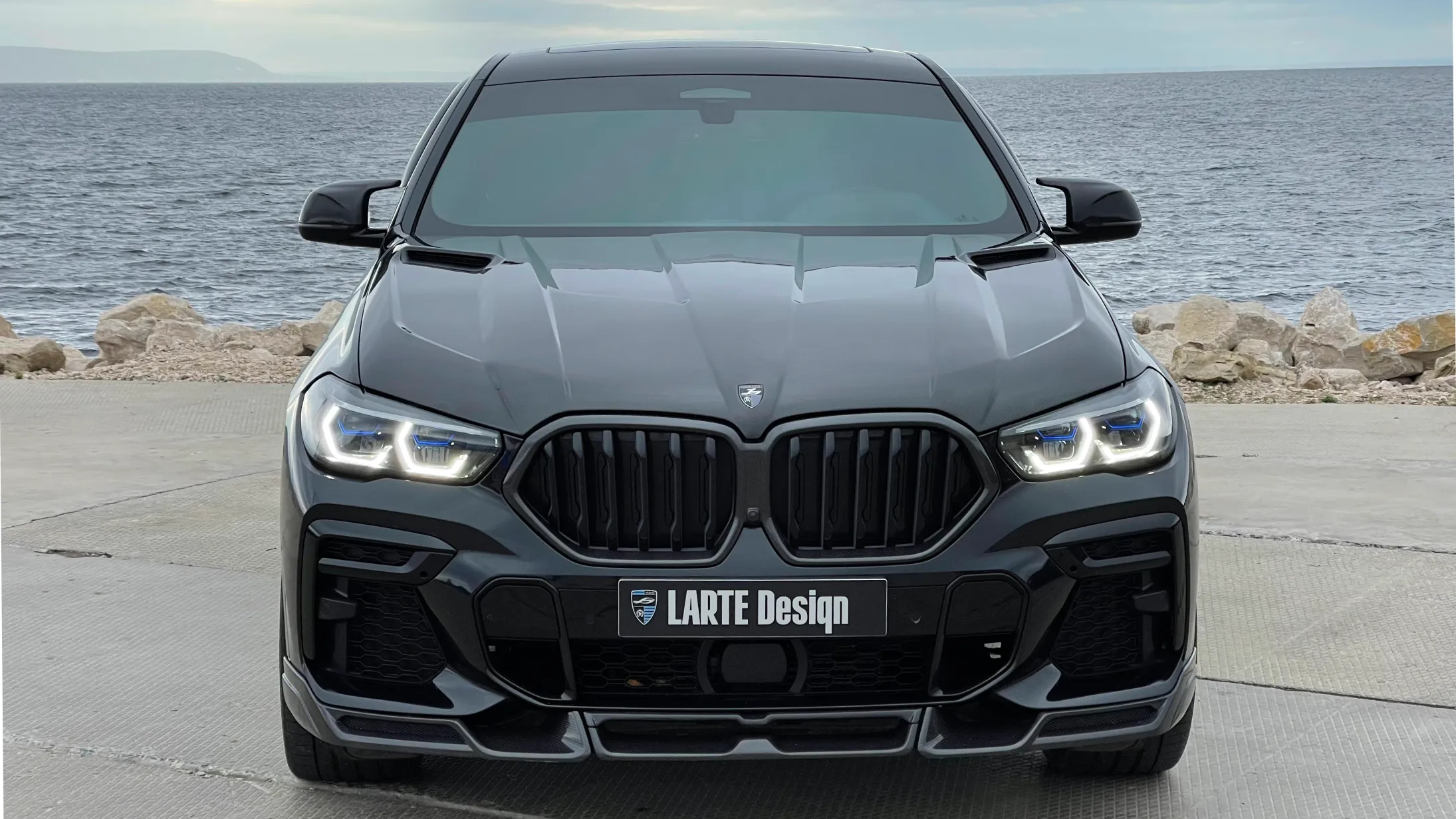 Front view on a BMW X6 with a body kit giving the car a custom appearance