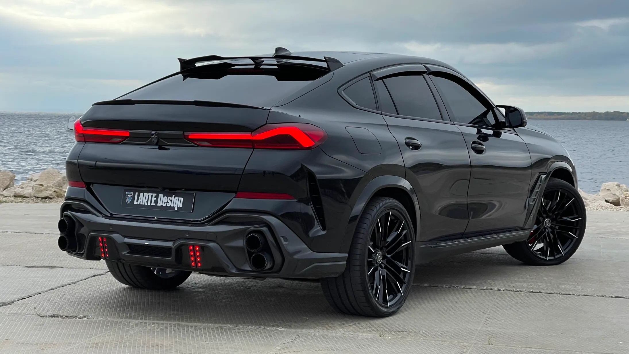 Rear angle view on a BMW X6 with a body kit giving the car a custom appearance