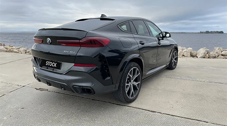 Rear angle view on a BMW X6 with a body kit giving the car a custom appearance