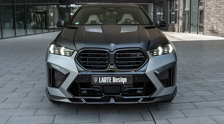 Front view on a BMW X6M F96 LCI Restyling with a body kit giving the car a custom appearance