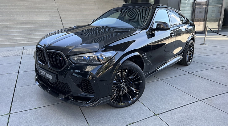 Front angle view on a BMW X6M with a body kit giving the car a custom appearance