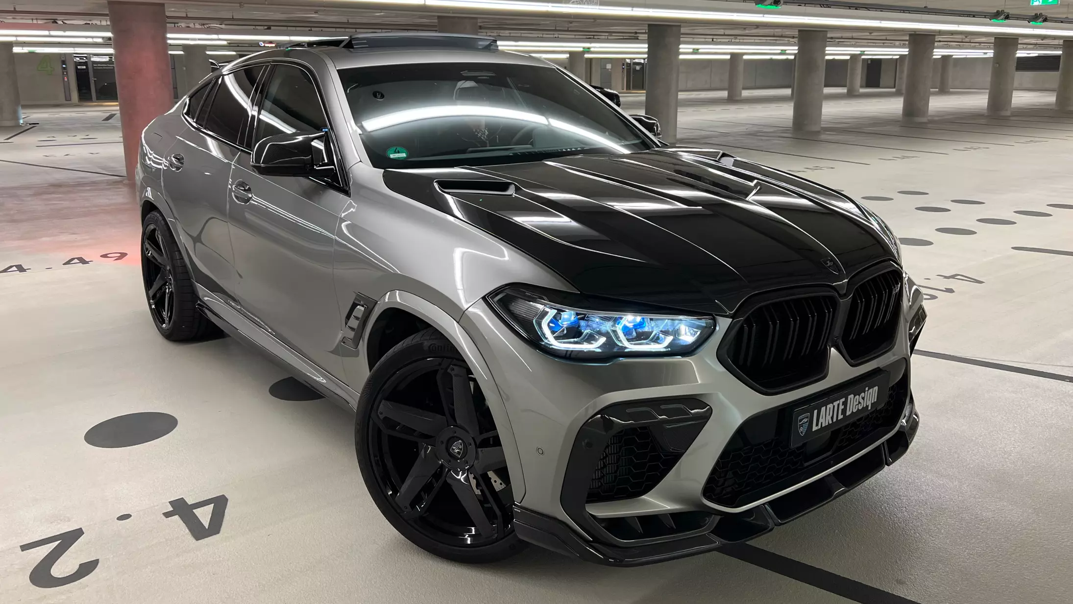 Front angle view on a BMW X6M with a body kit giving the car a custom appearance