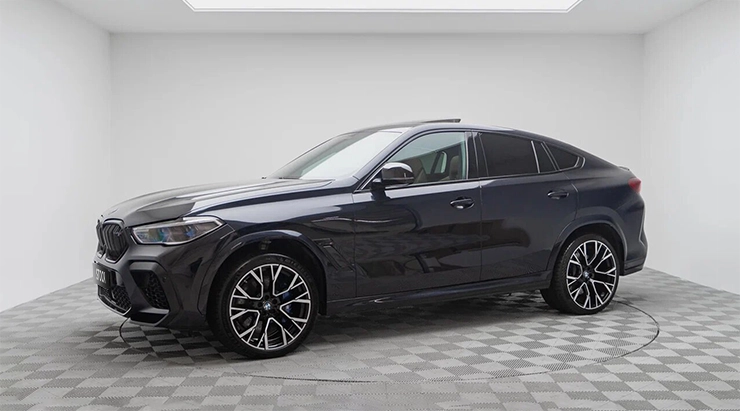 Front angle view on a BMW X6M with a body kit giving the car a custom appearance