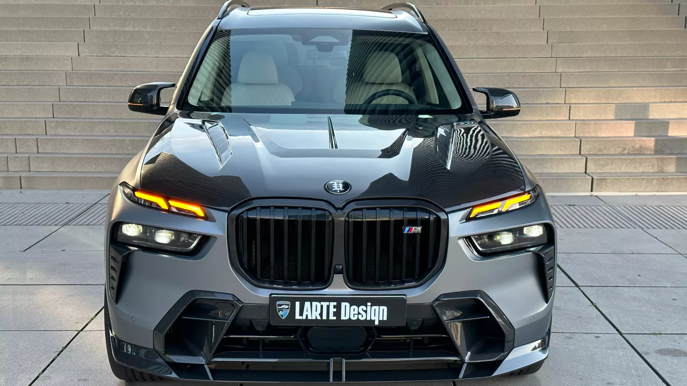 Front view on a BMW X7 with a body kit giving the car a custom appearance