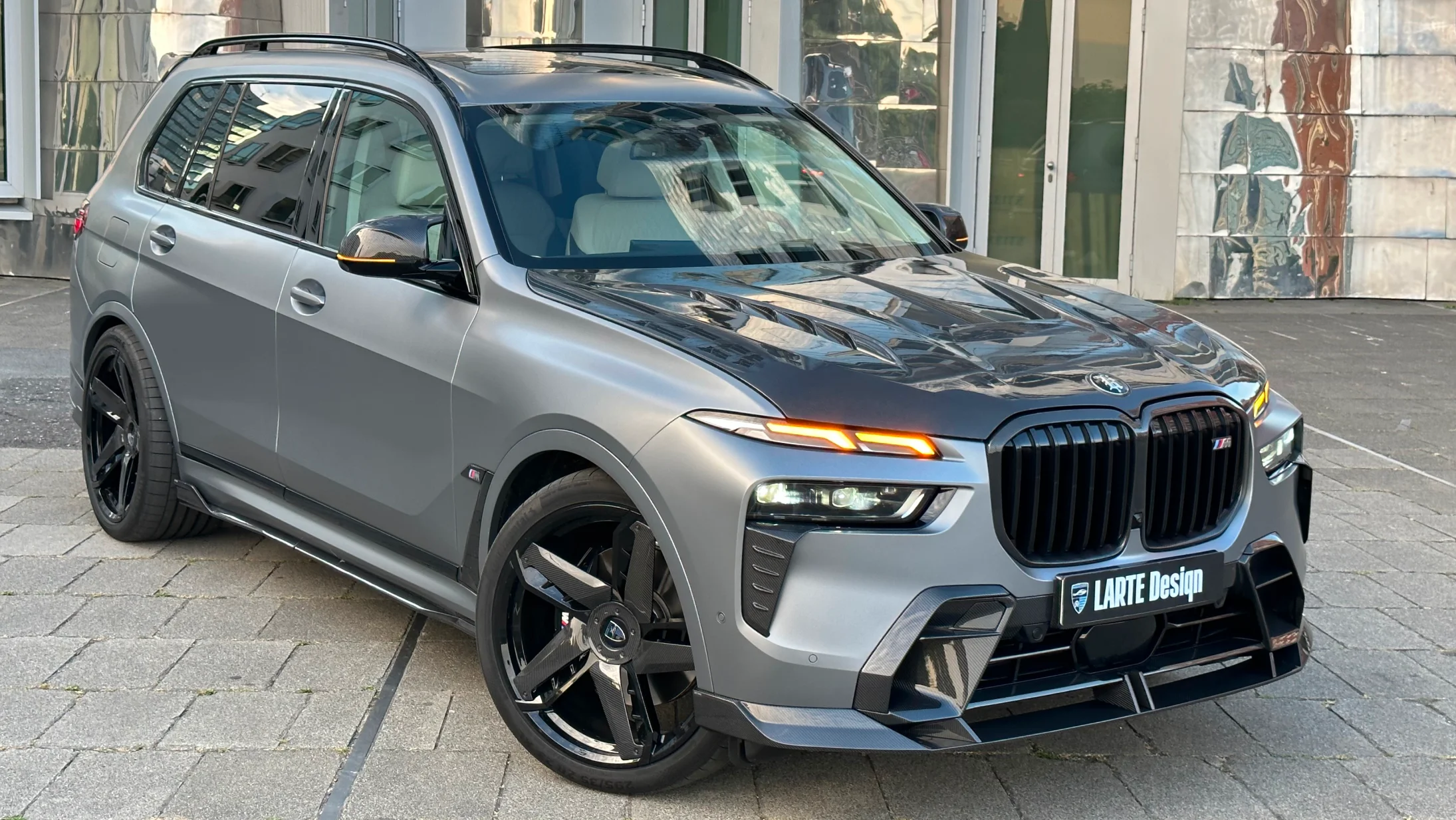 Front angle view on a BMW X7 with a body kit giving the car a custom appearance