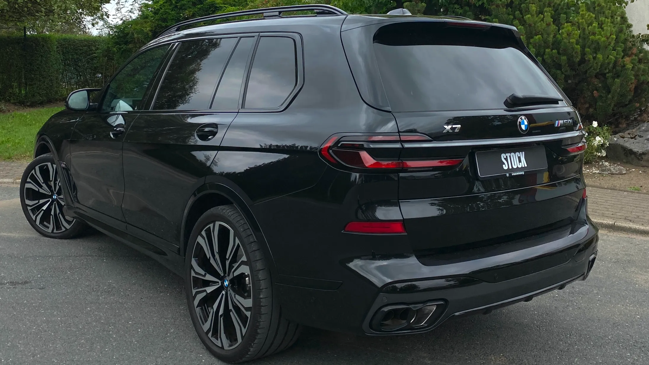Rear angle view on a BMW X7 with a body kit giving the car a custom appearance