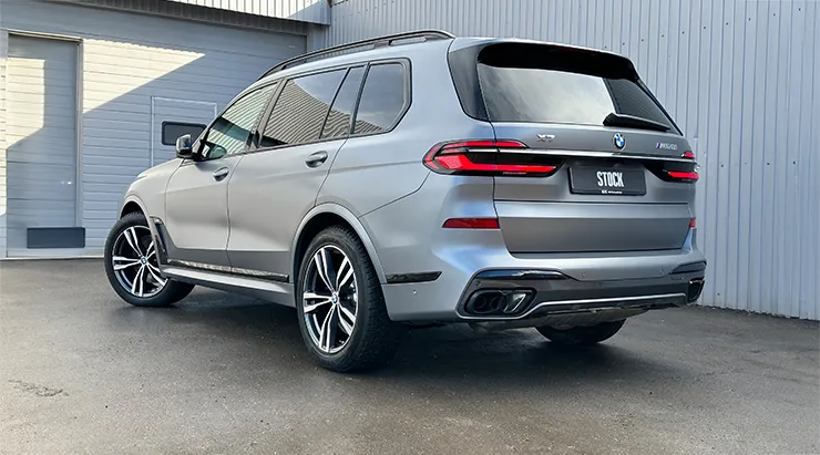 Rear angle view on a BMW X7 with a body kit giving the car a custom appearance