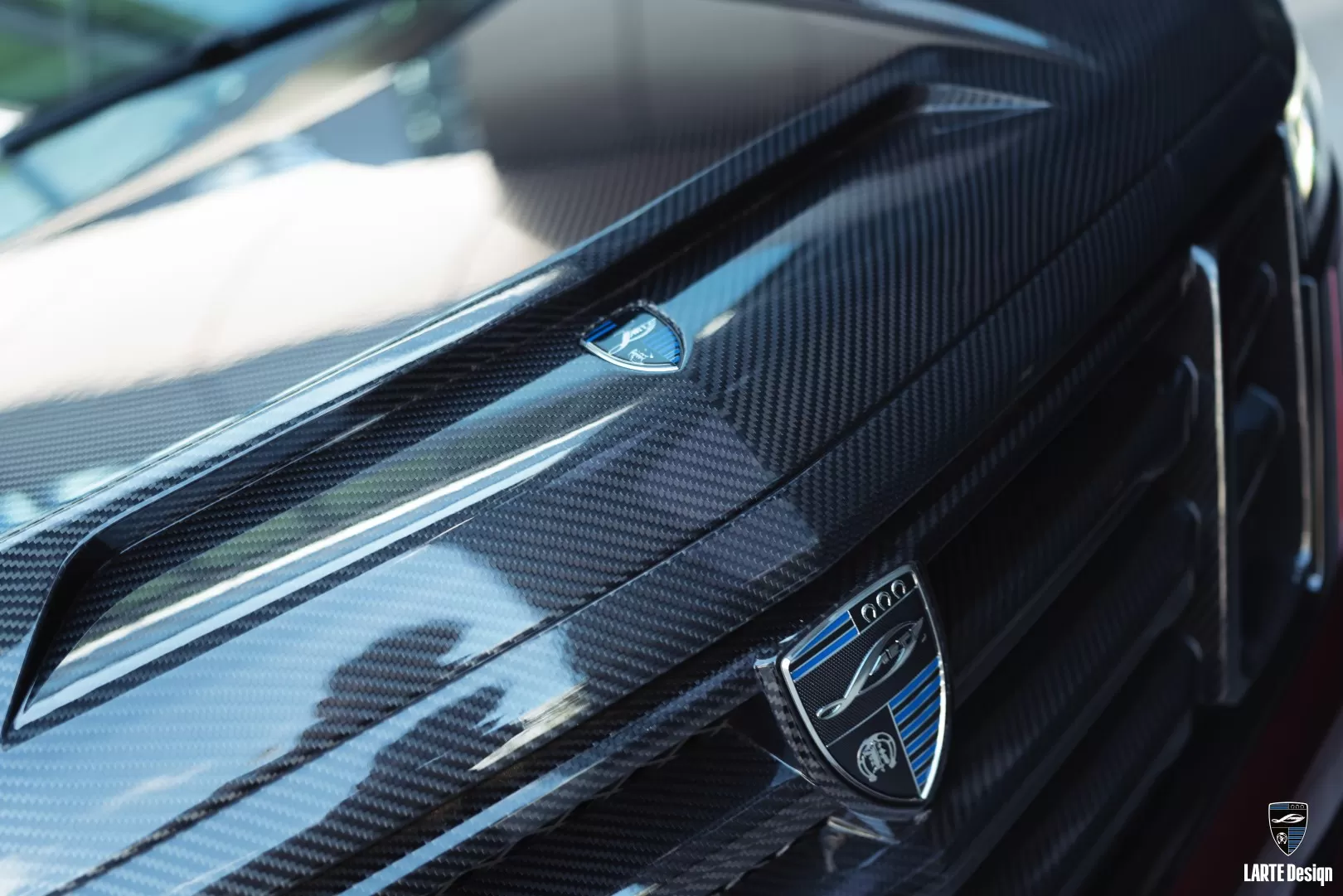 Closeup on a carbon fiber hood installed on Satin Steel Grey Cadillac Escalade-V / V-ESV