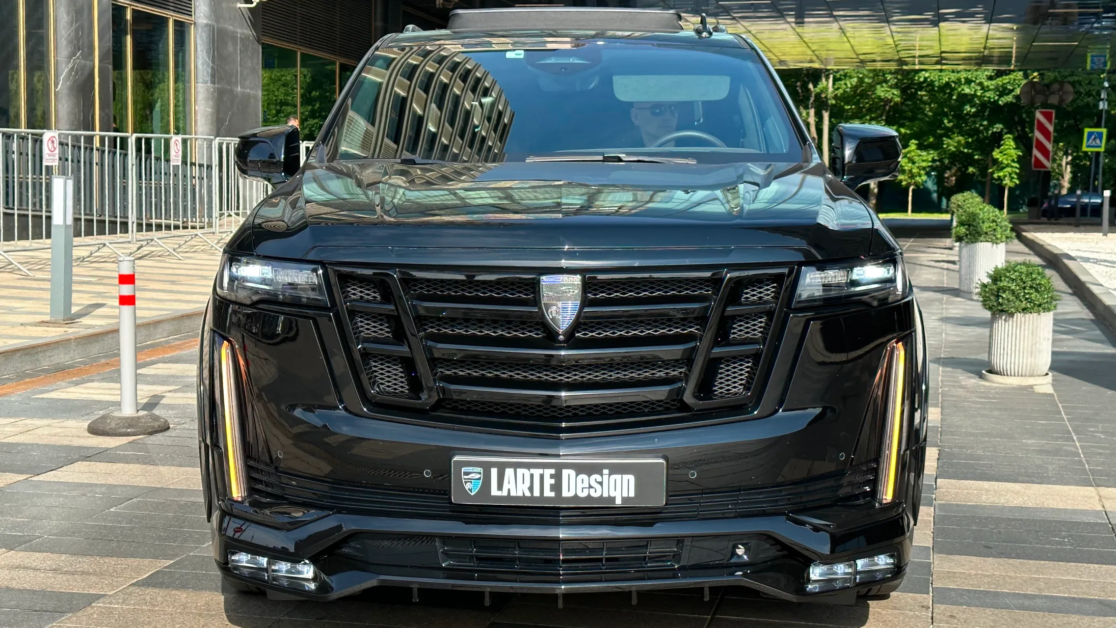 Front view on a Cadillac Escalade with a body kit giving the car a custom appearance