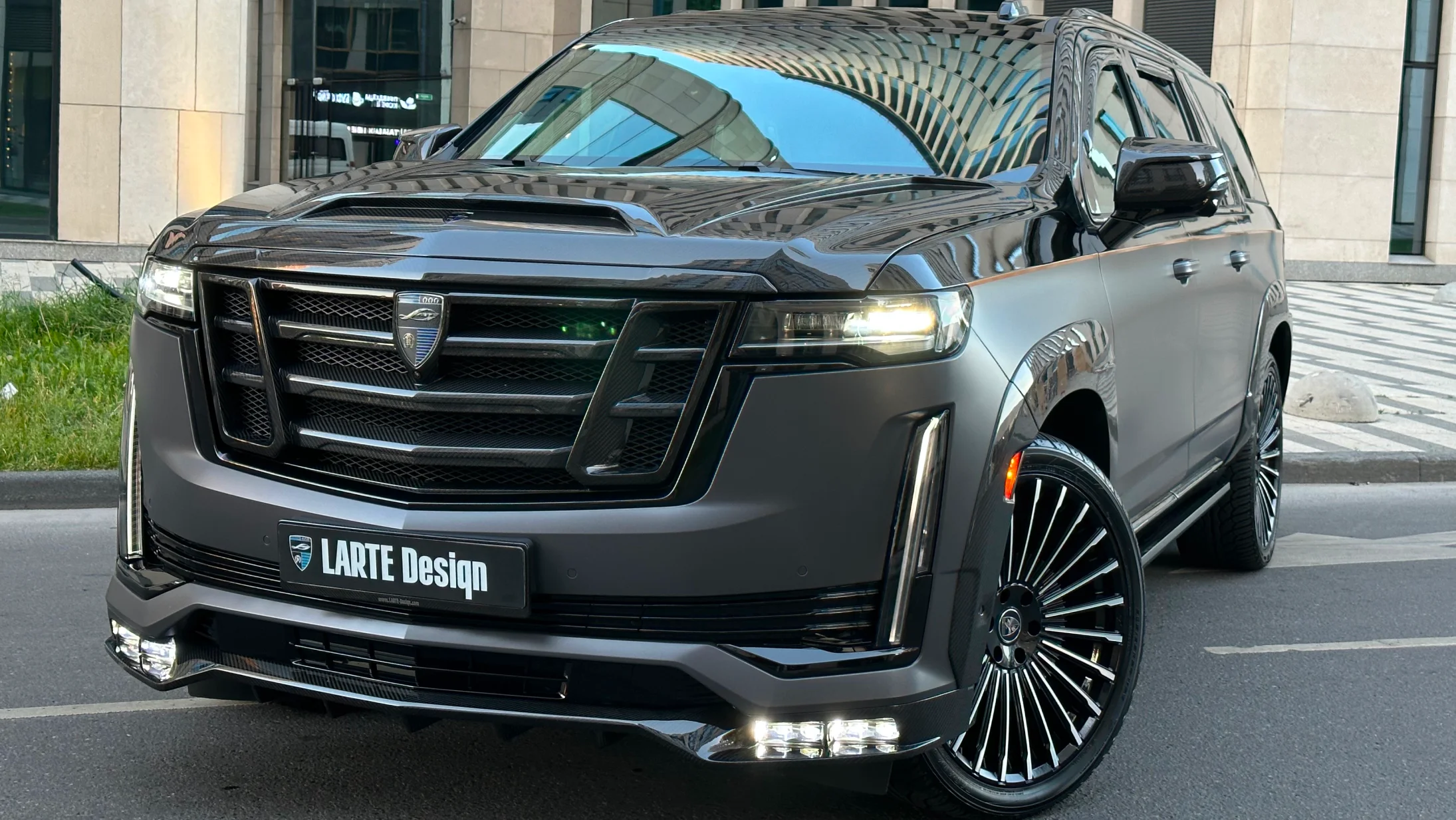 Front angle view on a Cadillac Escalade with a body kit giving the car a custom appearance