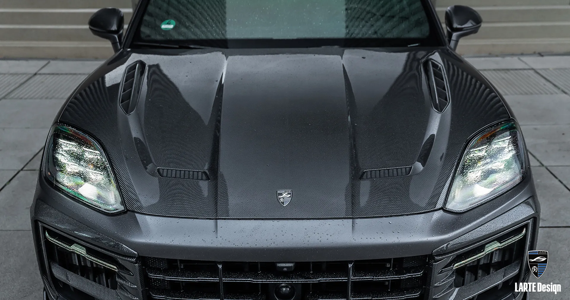 Custom-designed upgrade Porsche Cayenne Coupe S hood by Larte Design with lightweight carbon finish and sleek style.